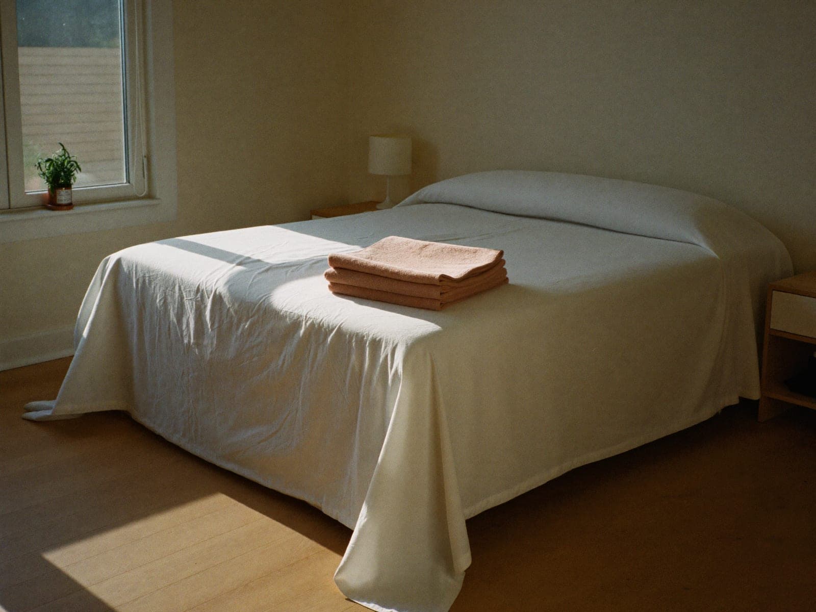 A short-term rental bedroom reset with fresh linens and a made bed.