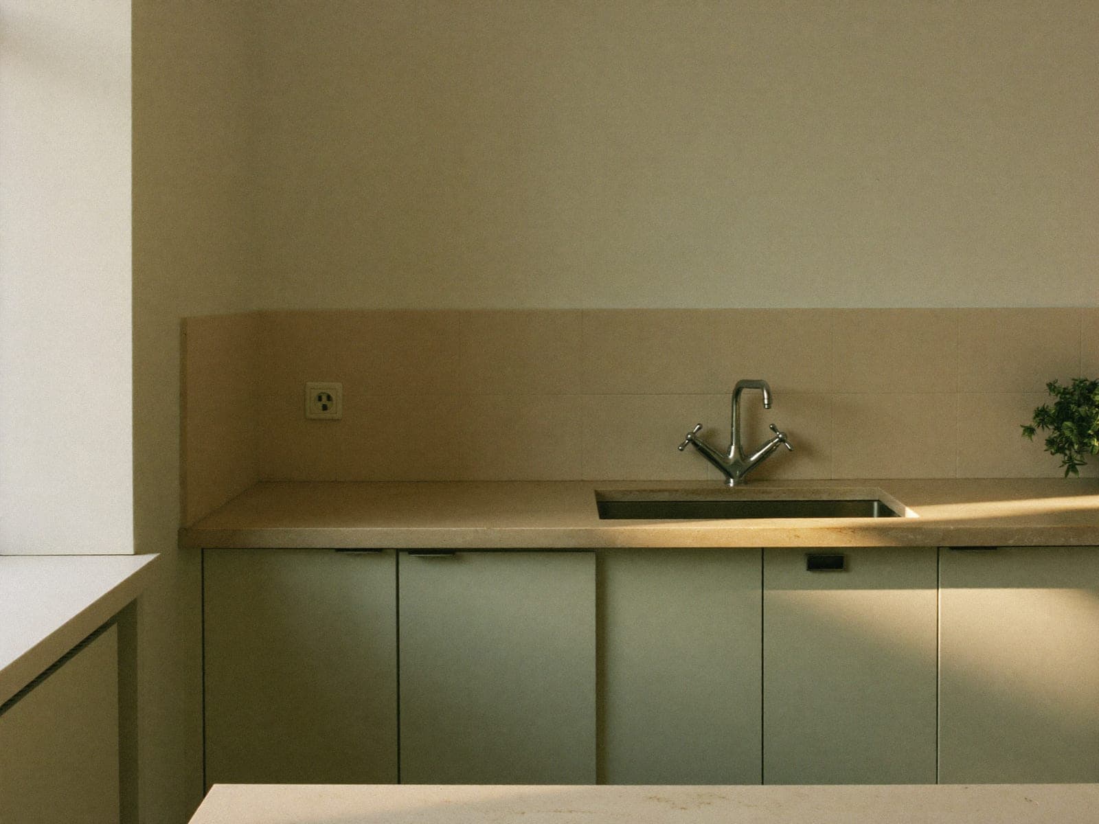 A kitchen counter wiped clean, with morning light across the surface.