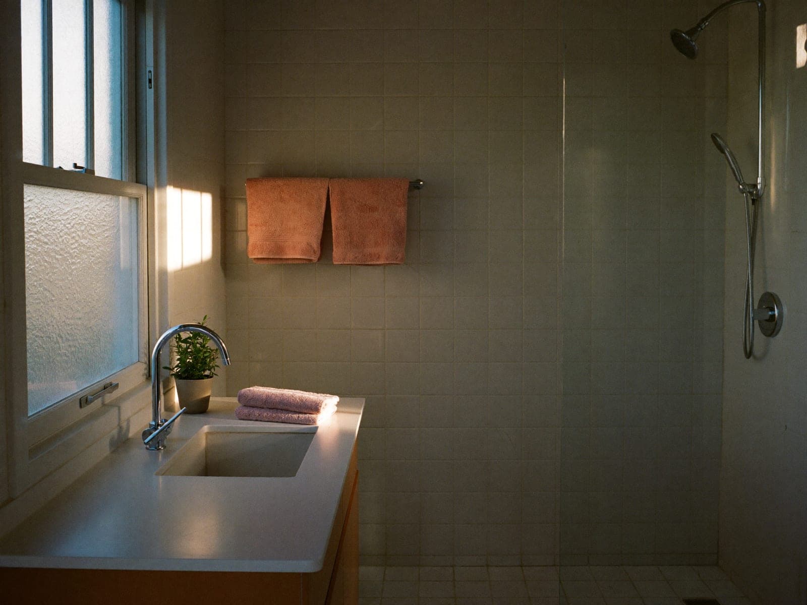 A bathroom after a deep clean, tile and chrome fixtures clear and dry.